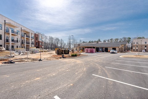 A parking lot with a building in the background.
